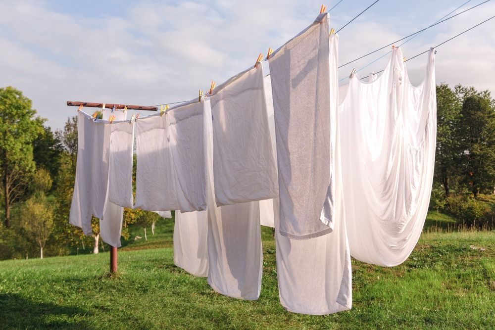 A Row of White Sheets Hanging on a Clothes Line in a Field — Tuncurry Washerteria In Tuncurry, NSW