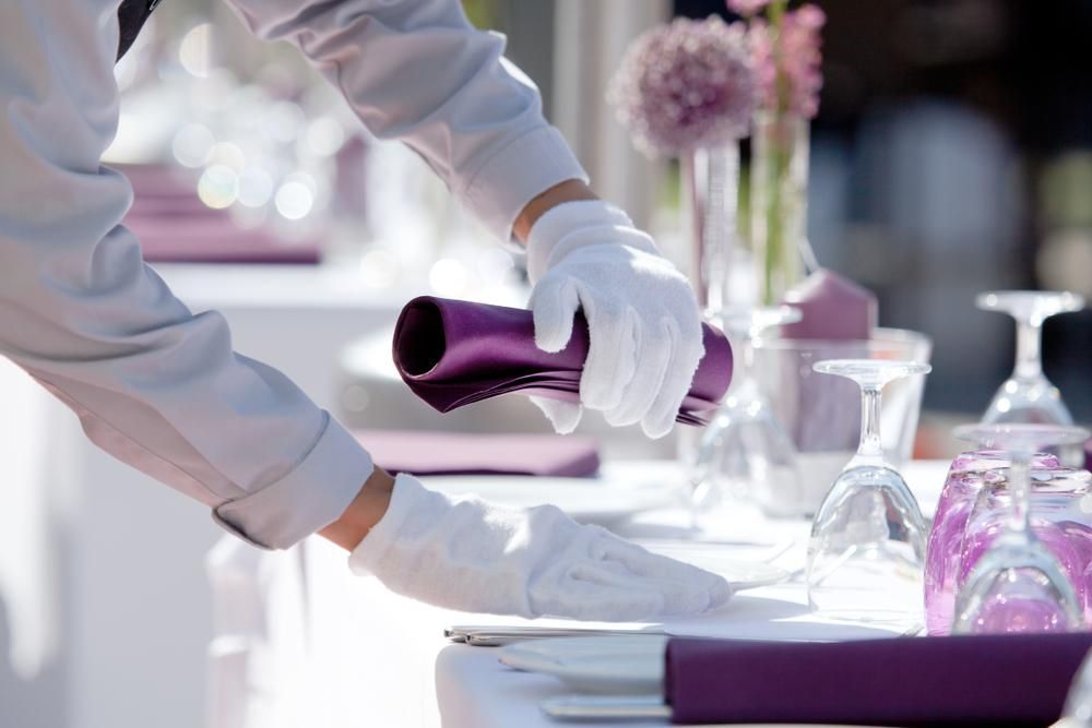 A Person Wearing White Gloves is Holding a Purple Object on a Table — Tuncurry Washerteria In Diamond Beach, NSW