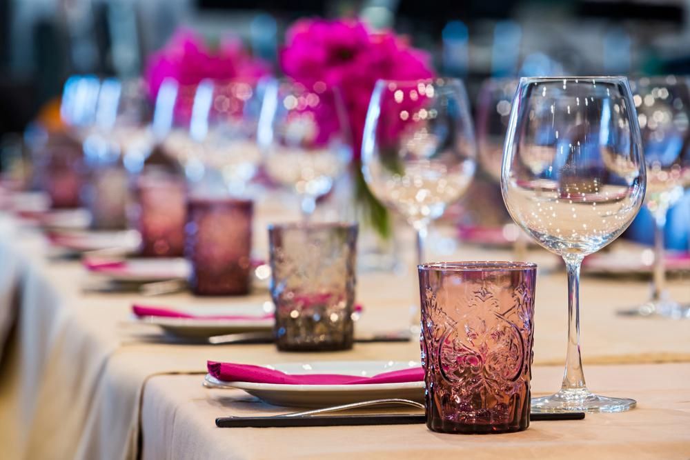 A Table Set for a Dinner Party With Wine Glasses and Plates — Tuncurry Washerteria In Pacific Palms, NSW