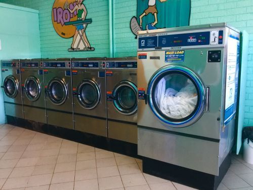 A row of washing machines in a laundromat. — Tuncurry Washerteria In Tuncurry, NSW