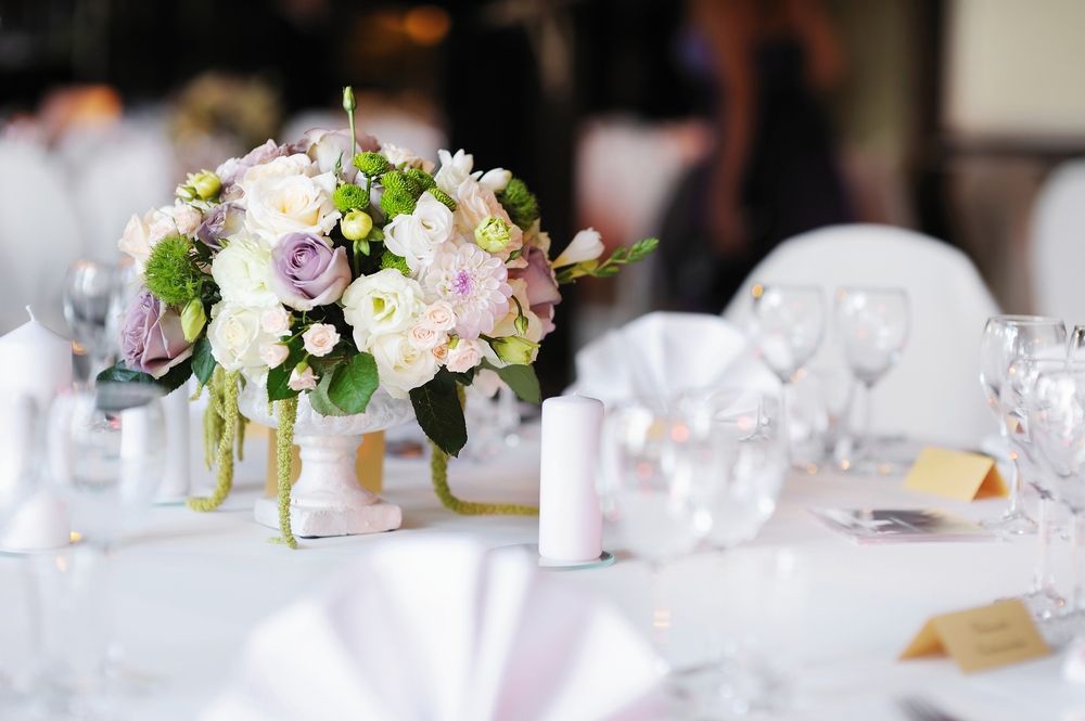 A Table Set for a Wedding Reception With a Vase of Flowers on It — Tuncurry Washerteria In Tuncurry, NSW