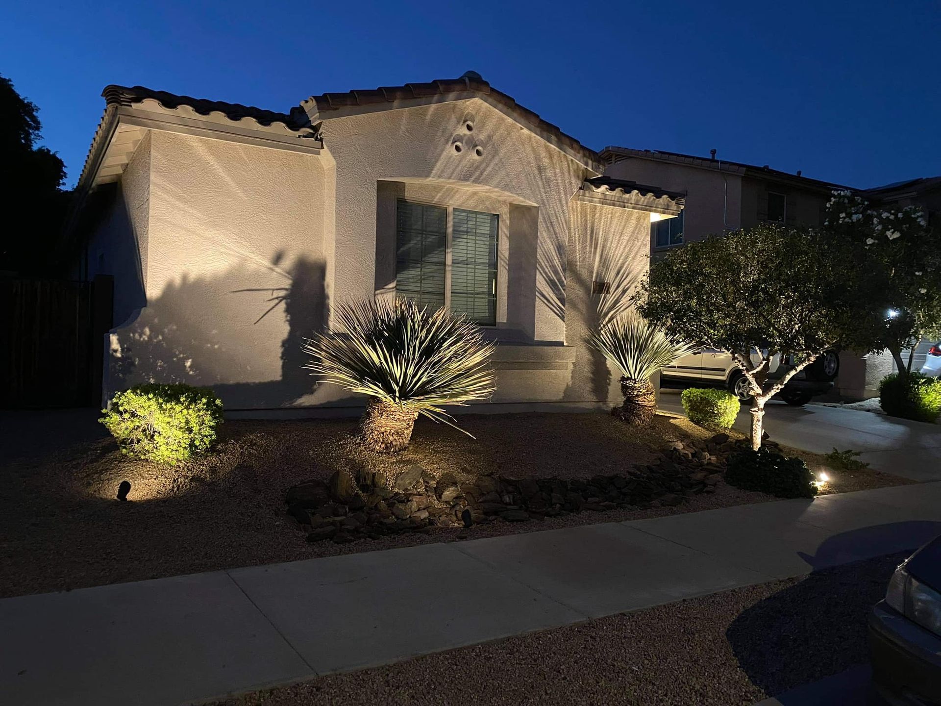 The front of a house is lit up at night