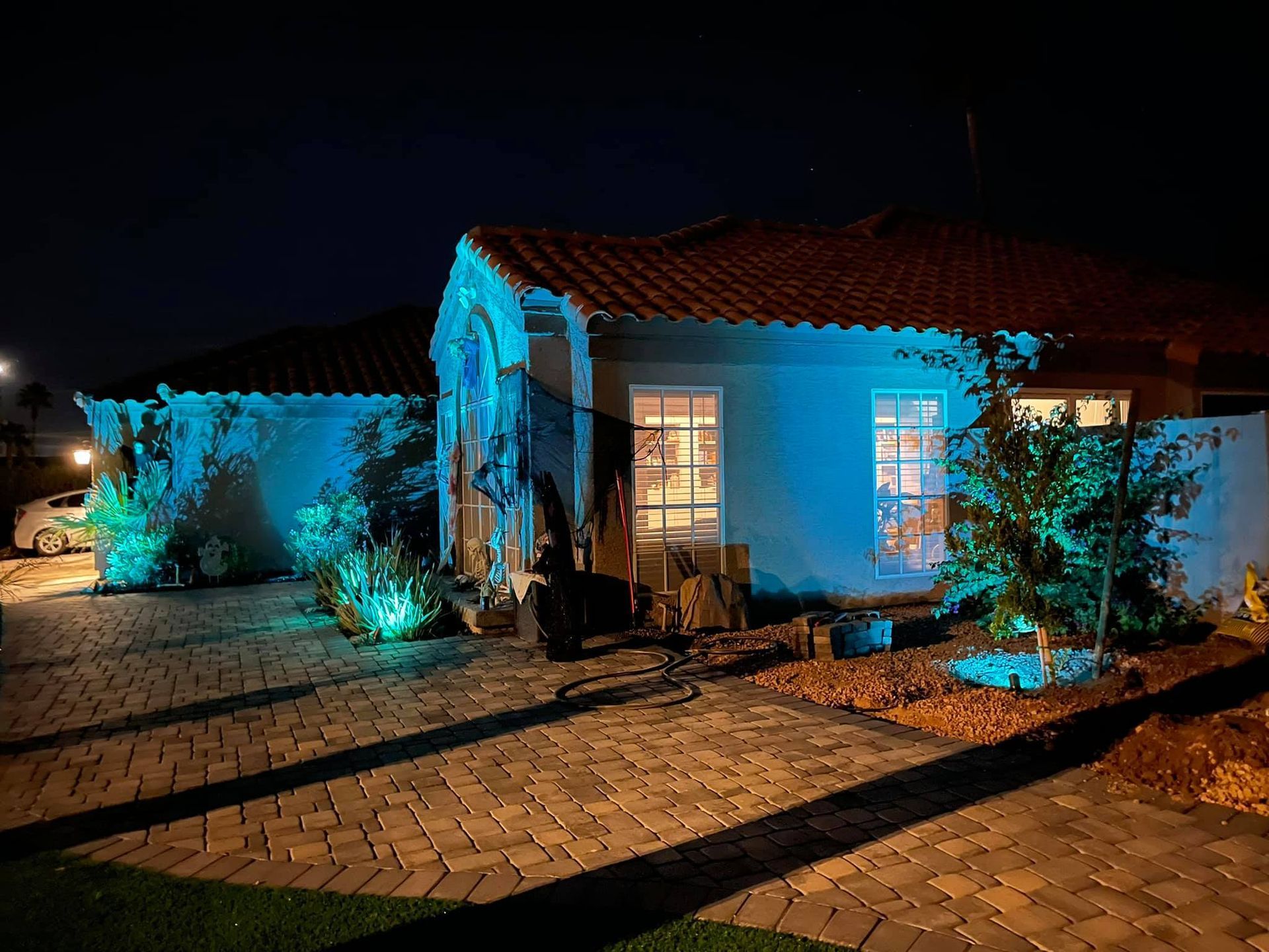 A house is lit up with blue lights at night.
