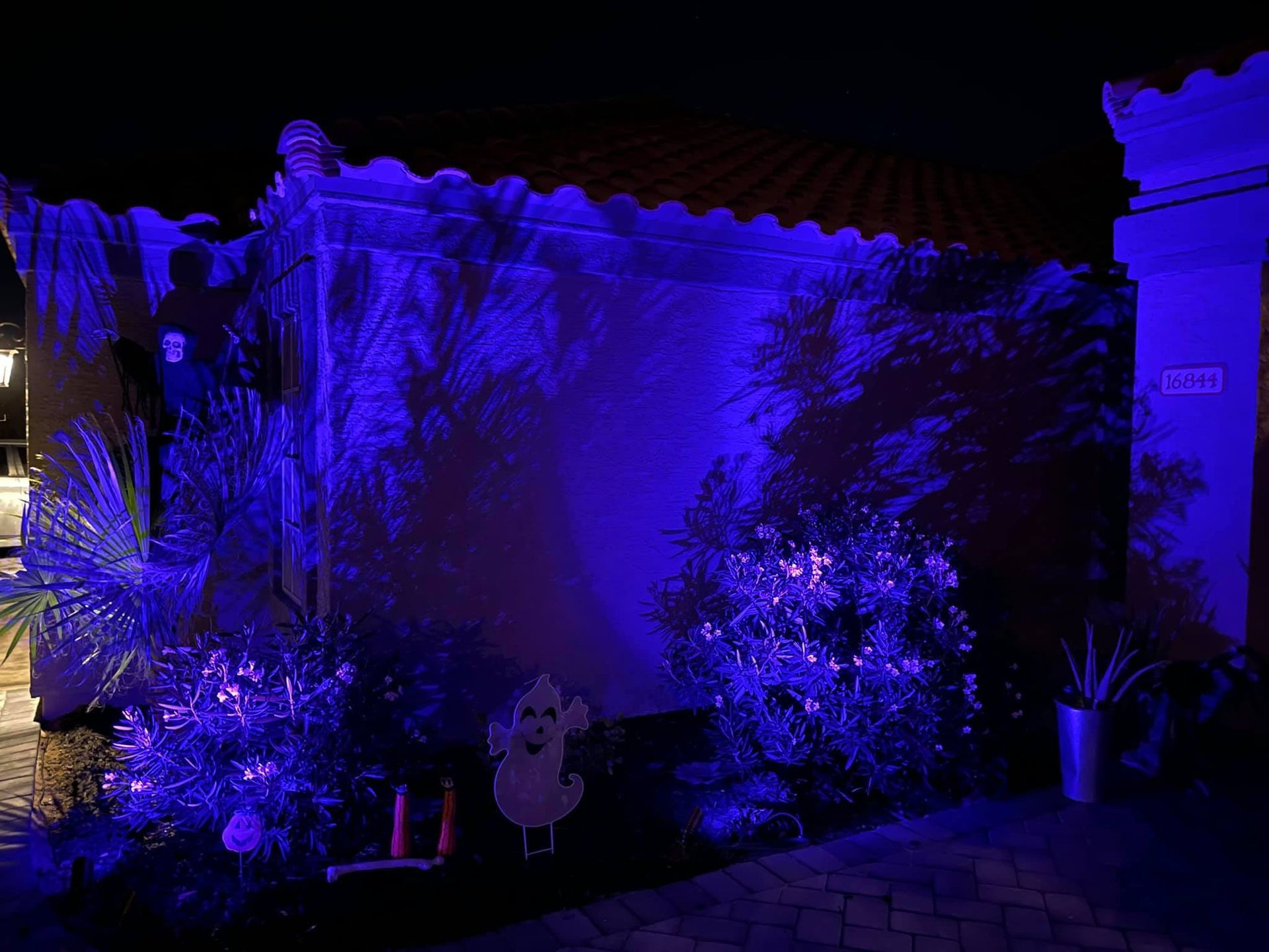 A house is lit up with blue lights at night.