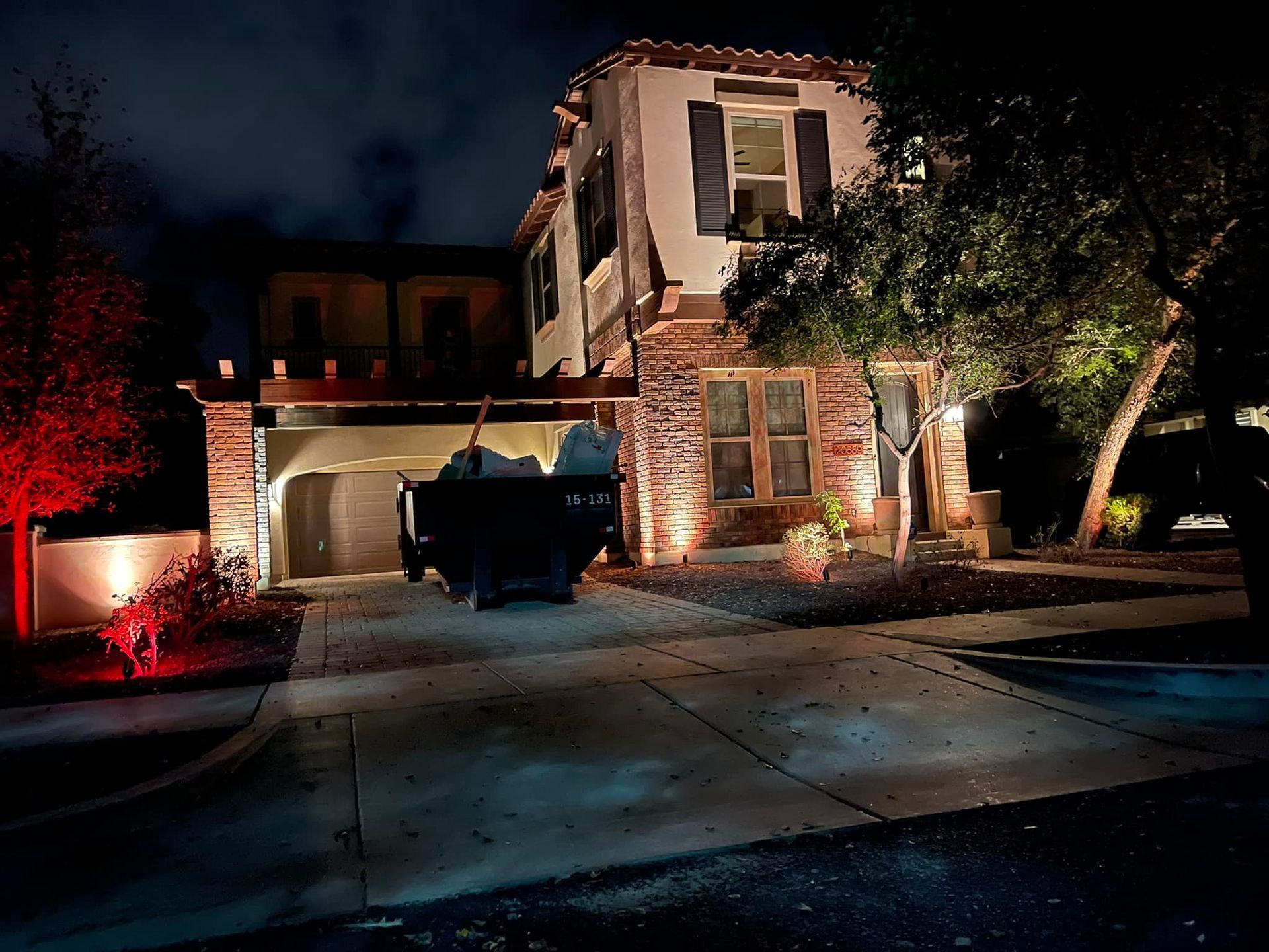 A truck is parked in front of a house at night