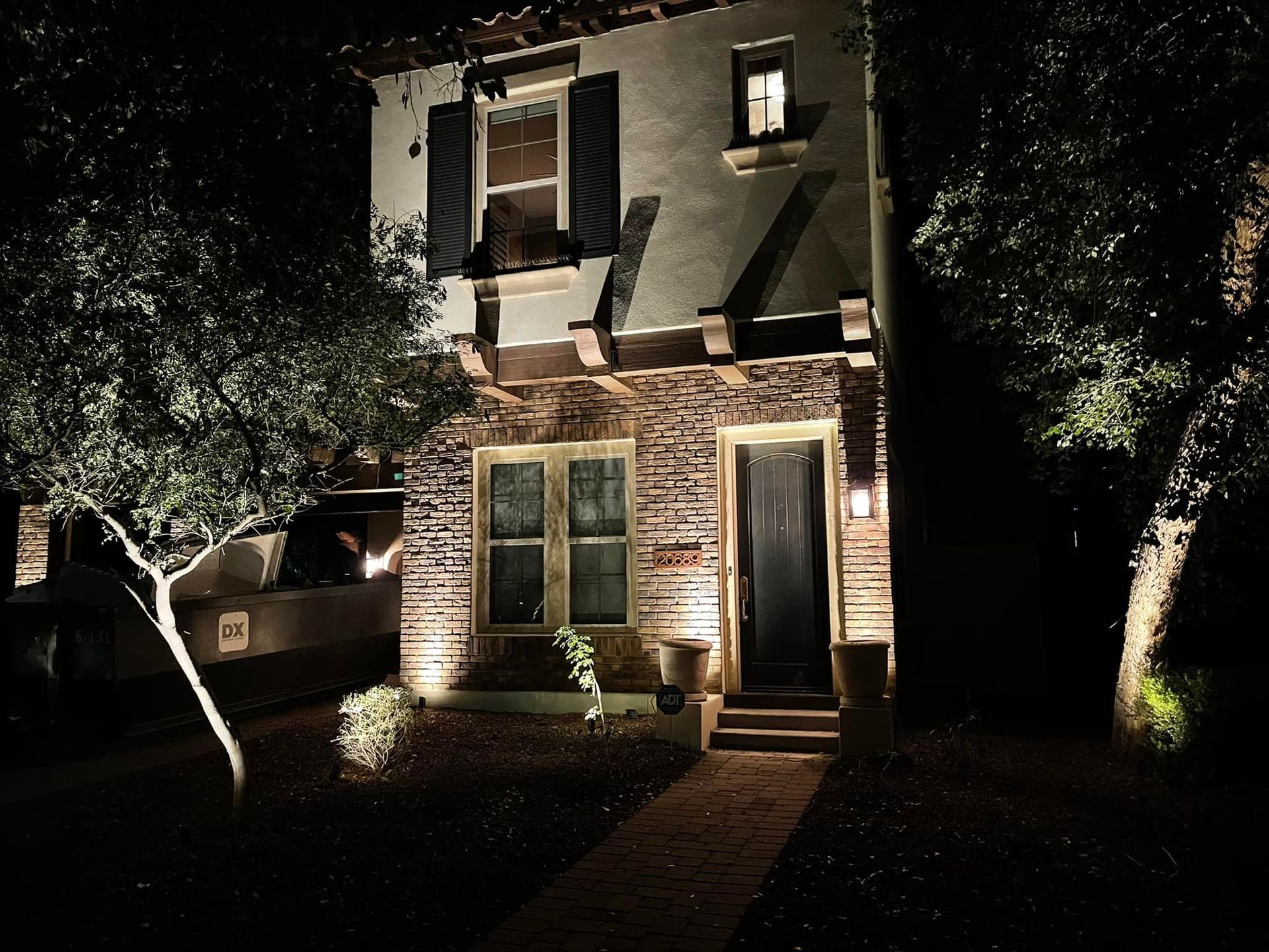 The front of a house is lit up at night