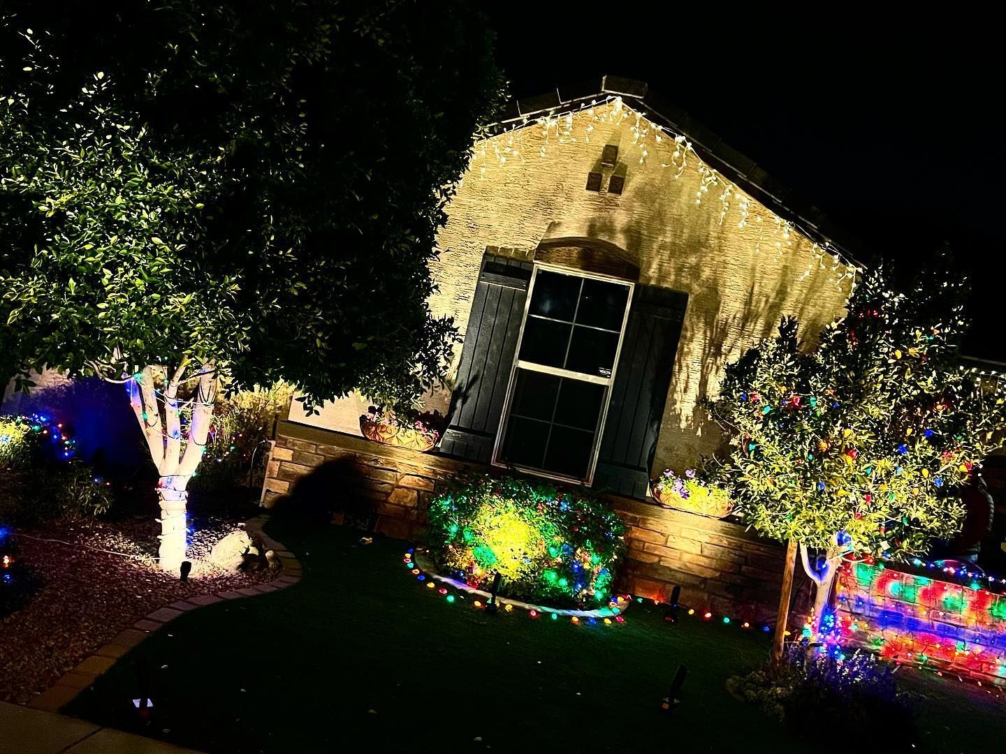 A house is decorated with christmas lights at night.