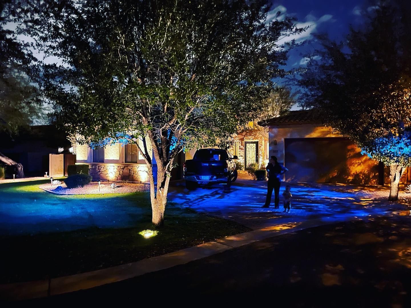 A house is lit up with blue lights at night.