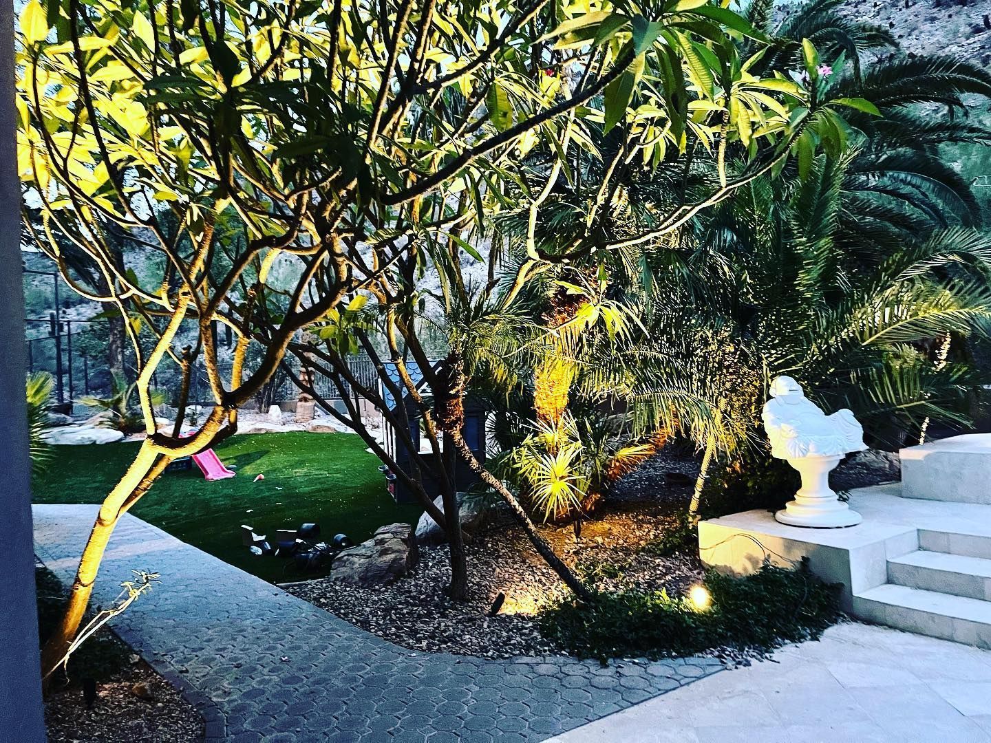 There is a statue of a bird in the middle of the garden.