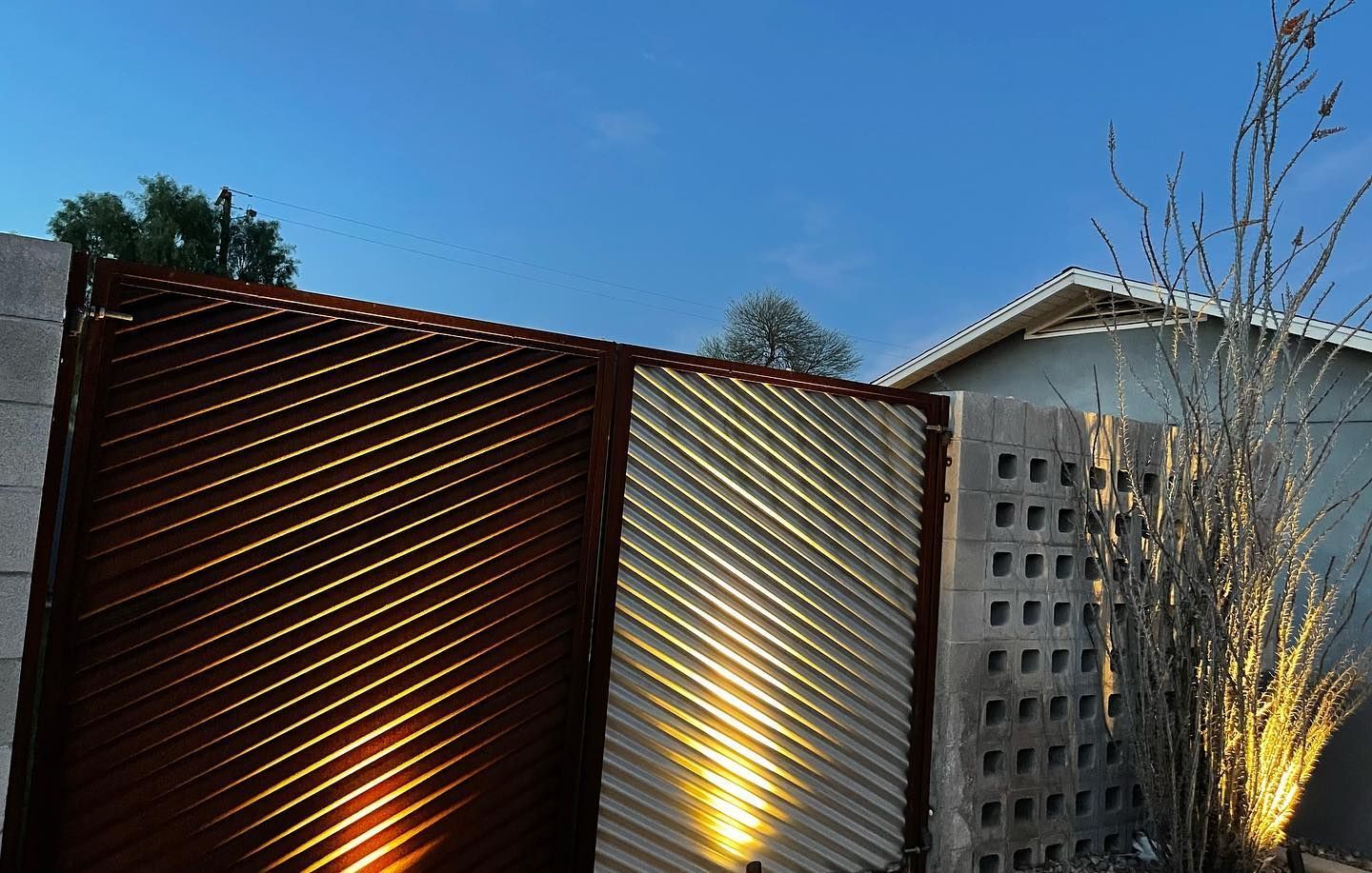 A building with a fence and a tree in front of it