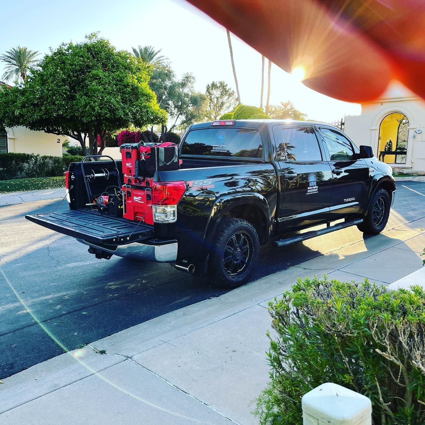 A black truck is parked on the side of the road