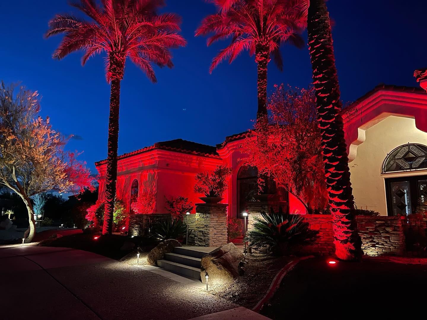 A house is lit up with red lights at night.