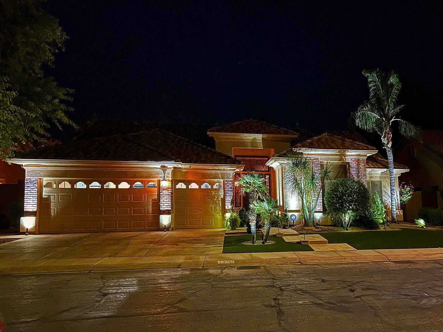 The front of a house is lit up at night