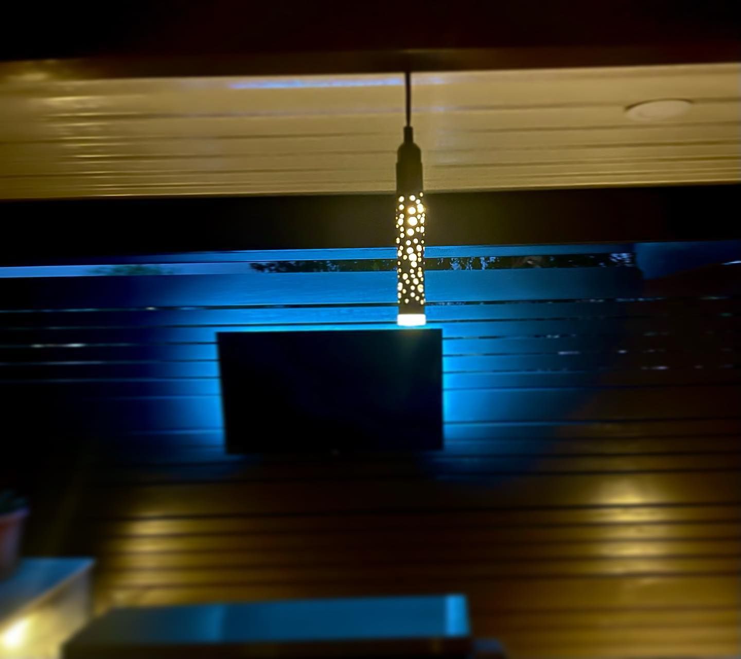 A light hanging from the ceiling in a dark room