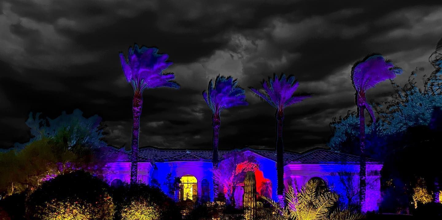A house is lit up with purple lights at night.