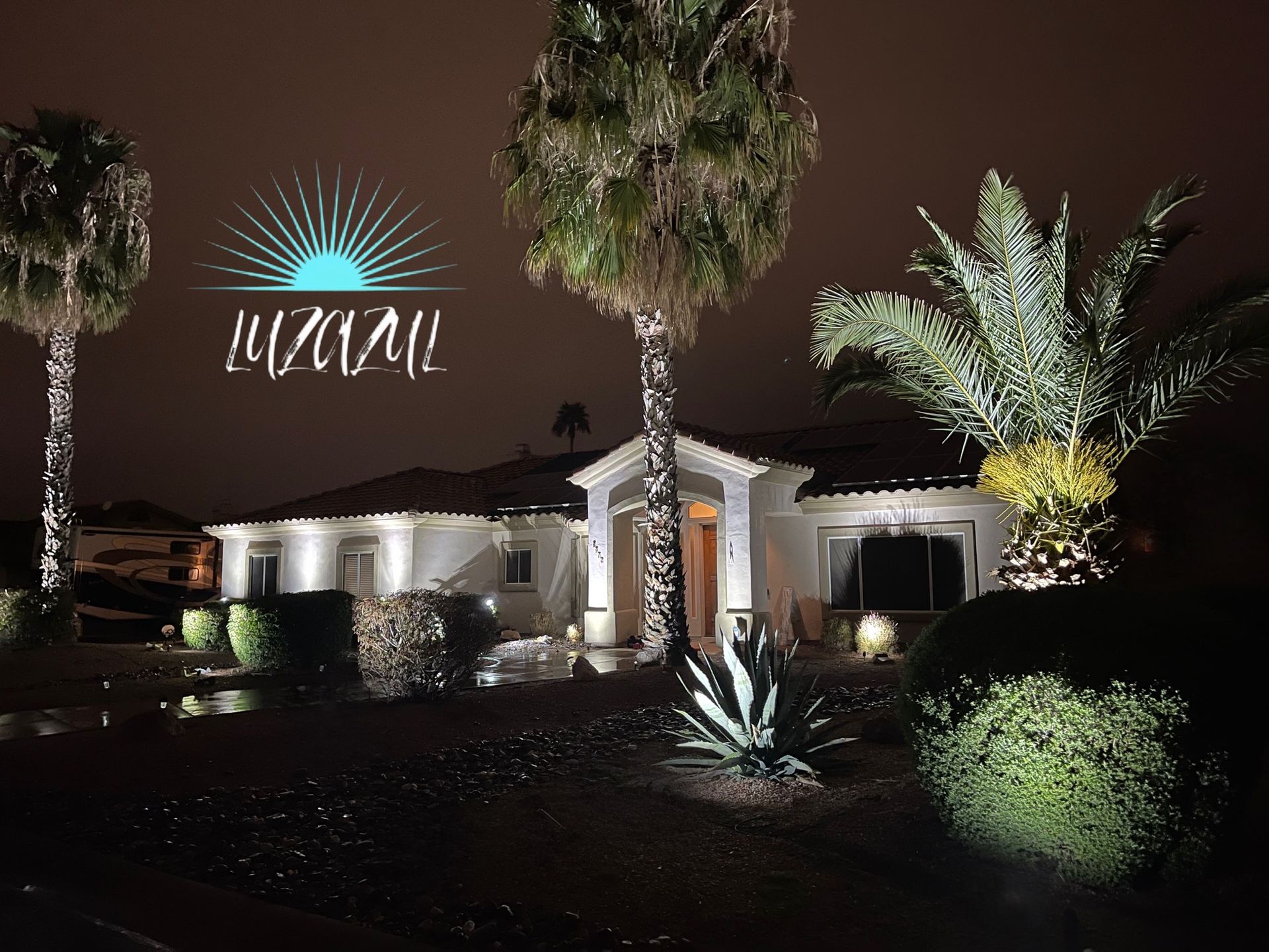 A house with palm trees in front of it and a logo that says luzial