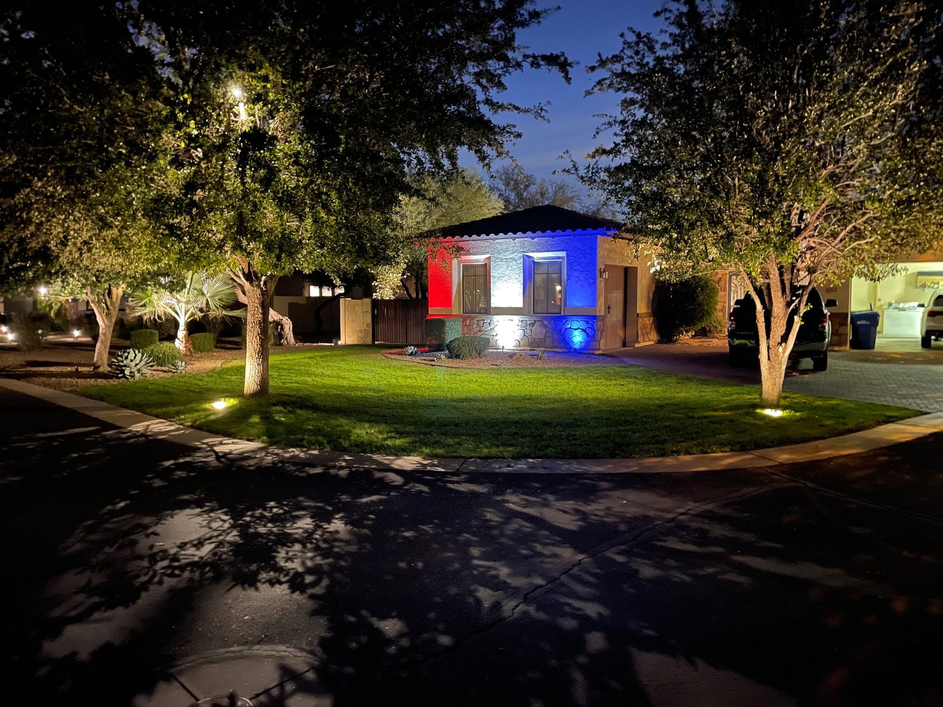 A house is lit up with red , white and blue lights.