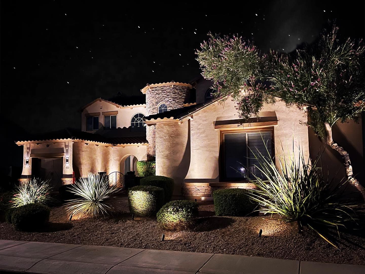 The front of a house is lit up at night