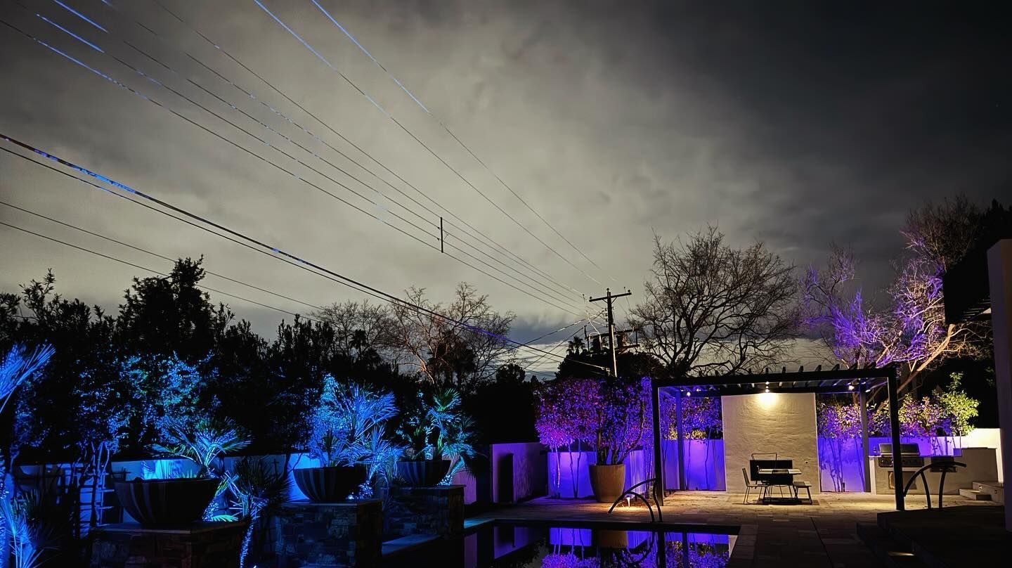 A house is lit up with purple lights at night