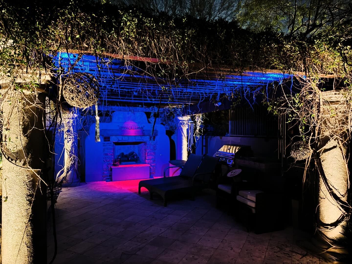 A dark room with purple and blue lights on the ceiling