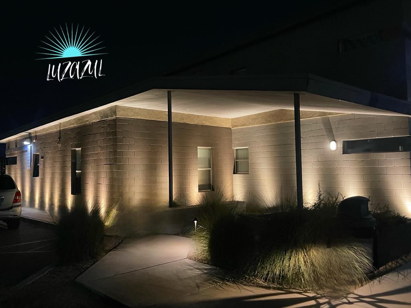 A building with a lot of lights on it is lit up at night.