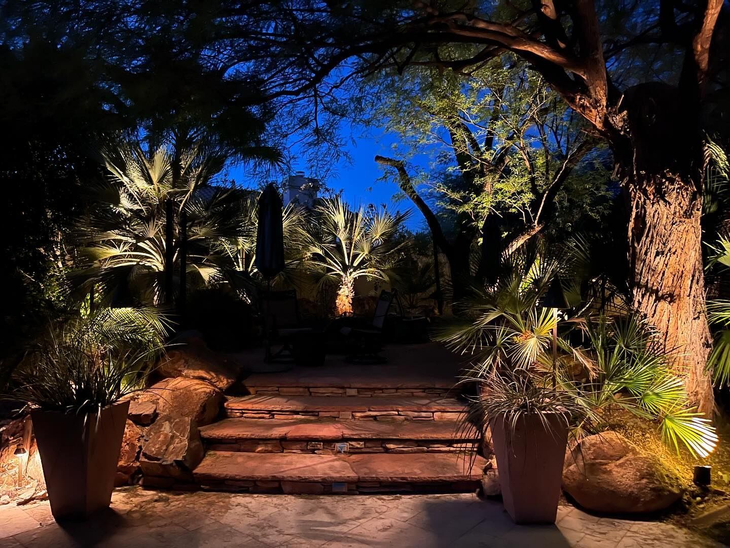 A staircase is lit up at night in a garden