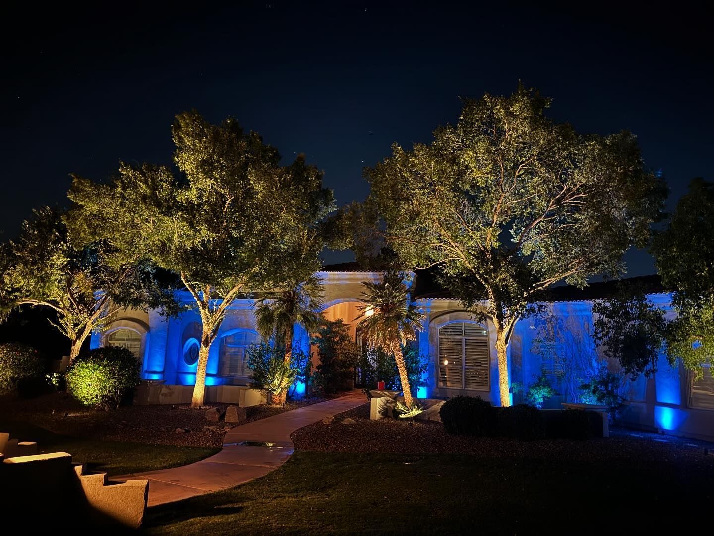 A house is lit up with blue lights at night.