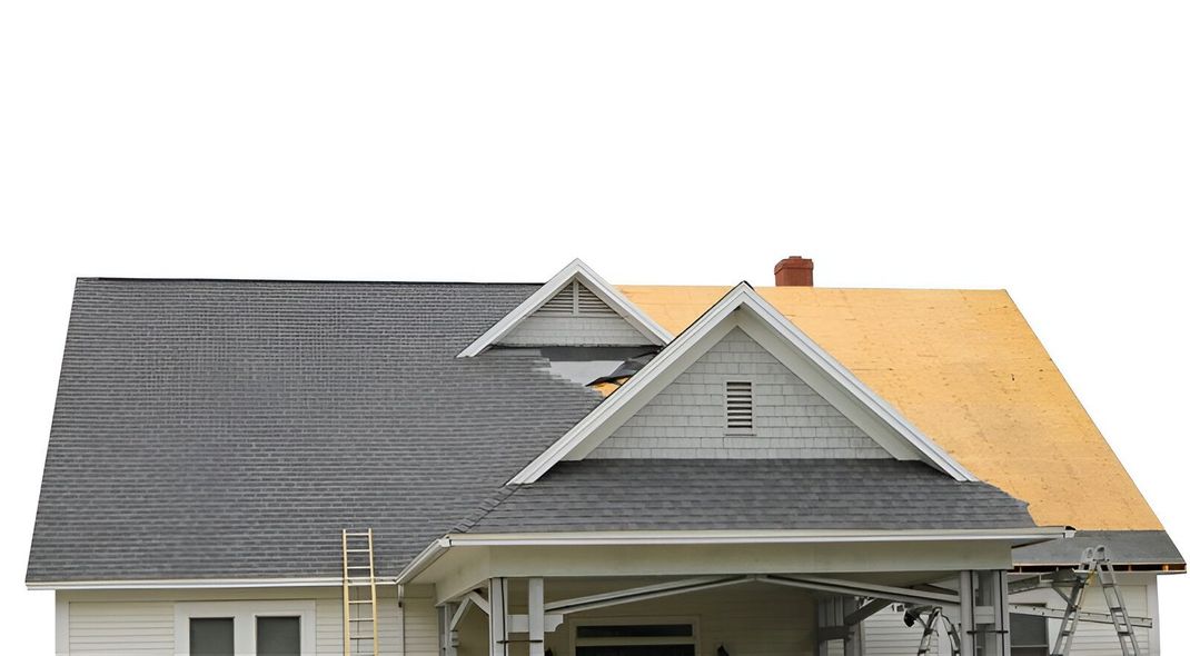 House with roof partially replaced, showing new gray shingles and exposed wood.