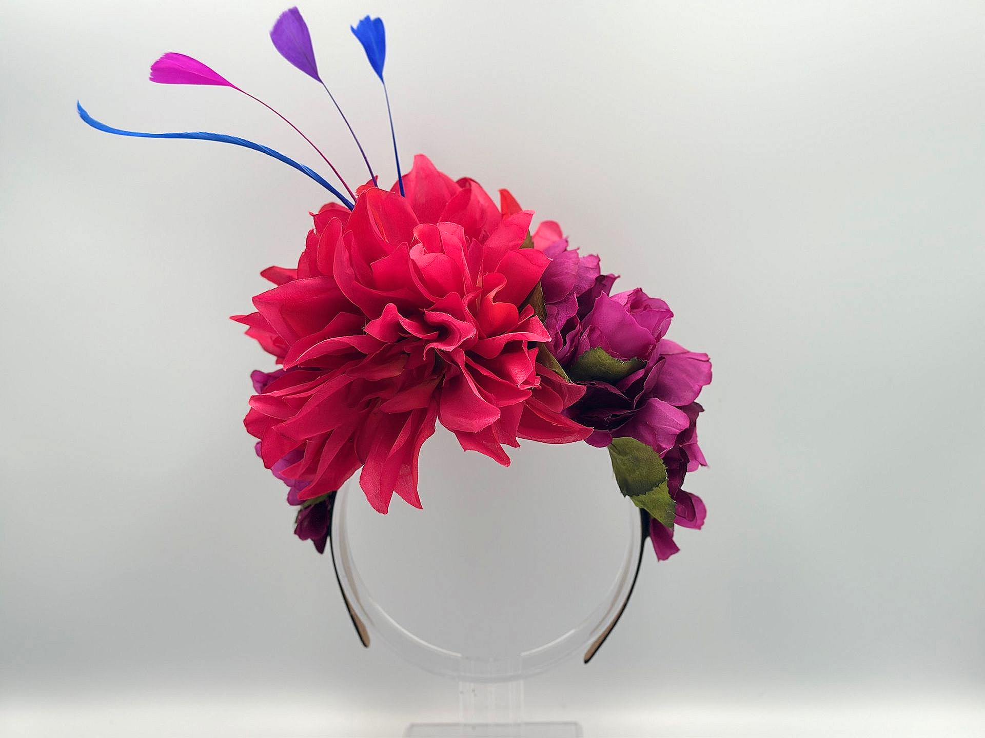 Headband with pink and purple flowers, blue and purple feathers.