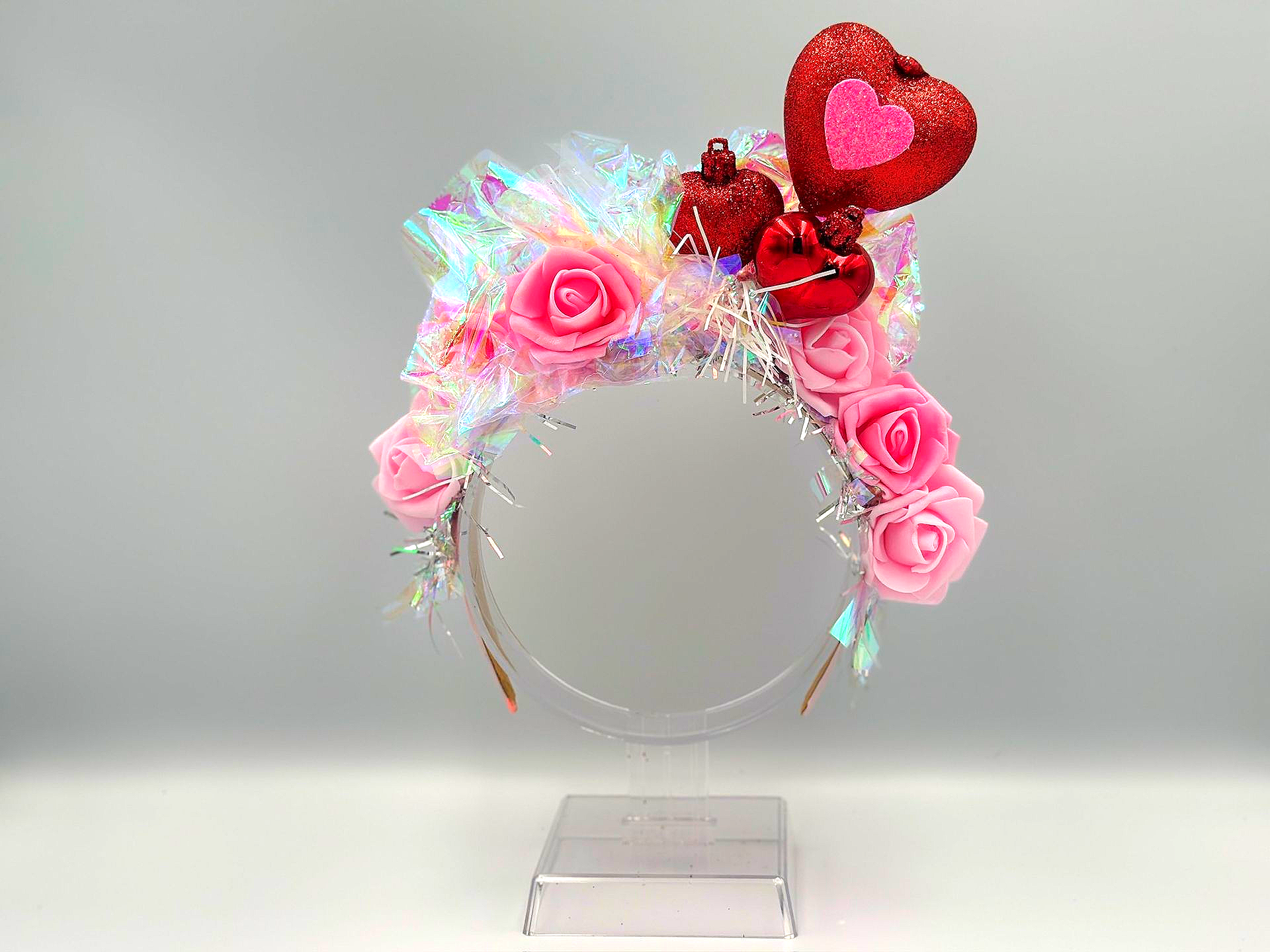 Headband decorated with pink roses, glitter, and a red heart.