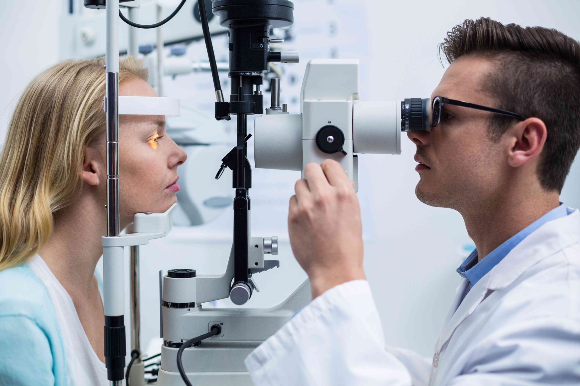 a woman is getting her eyes examined by an ophthalmologist