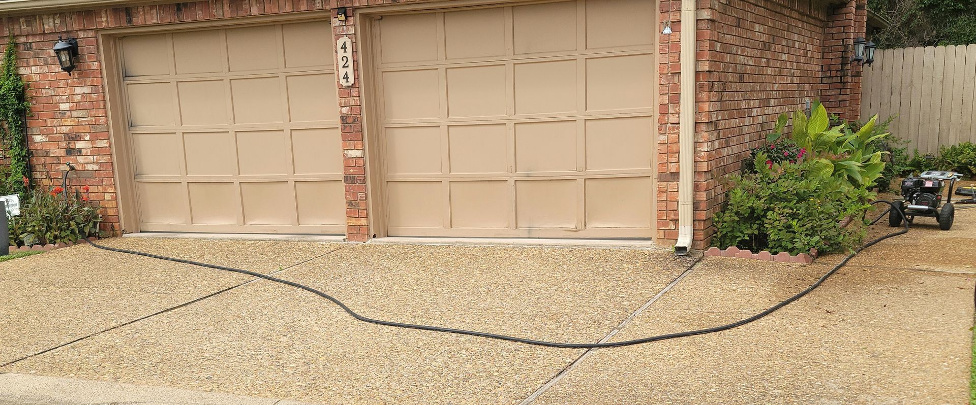 A person is using a pressure washer to clean a concrete floor.