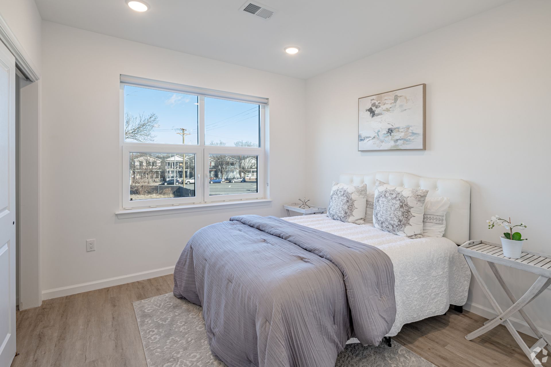 A bedroom with a large bed and a window.- The Unity