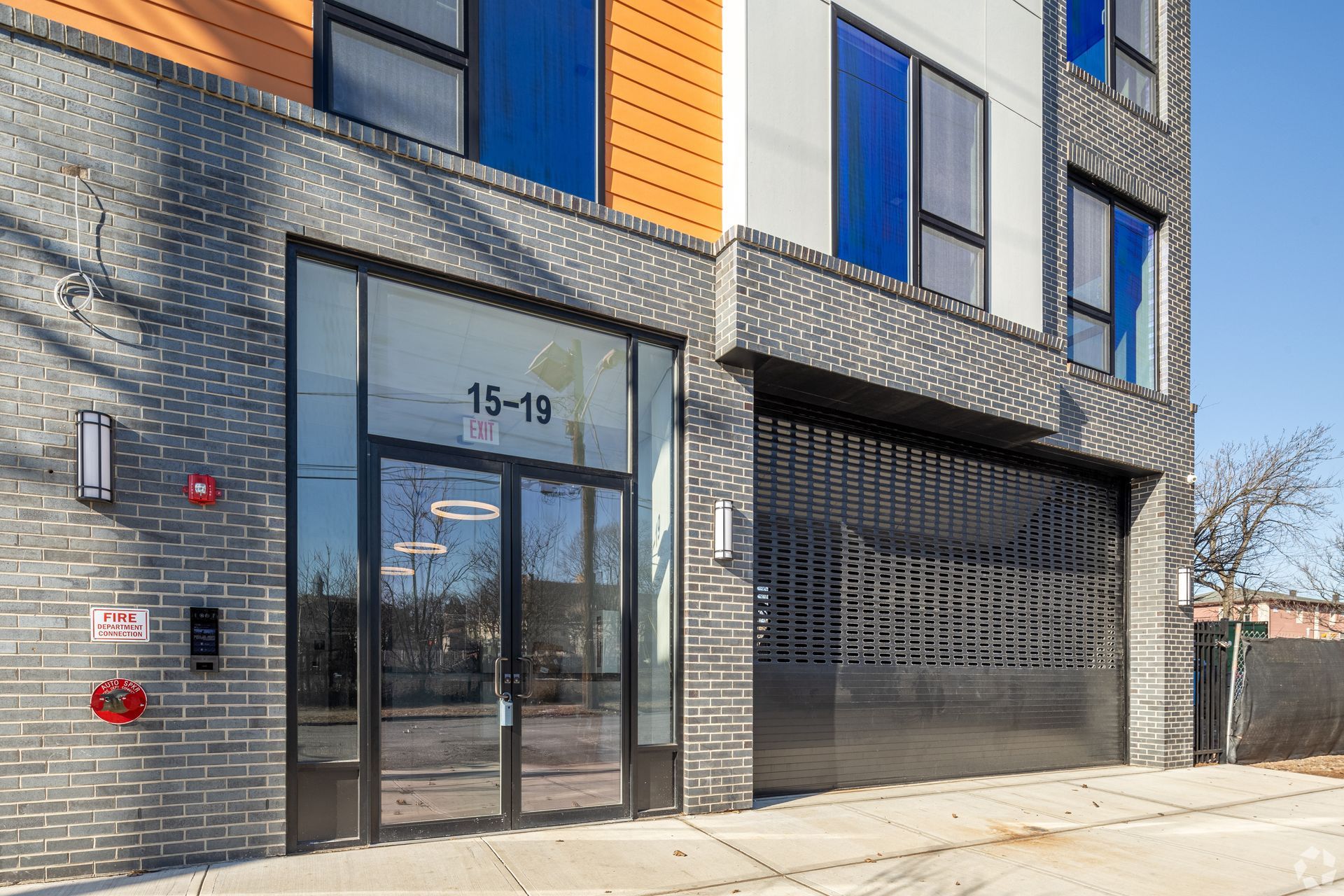 A large building with a lot of windows and a garage door.- The Unity