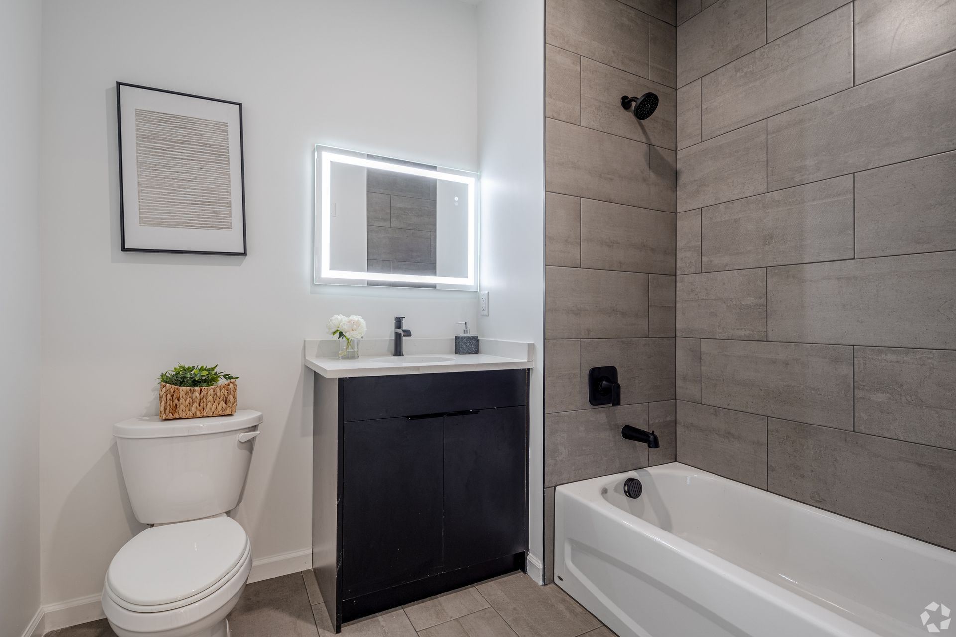 A bathroom with a toilet , sink , and bathtub.- The Unity