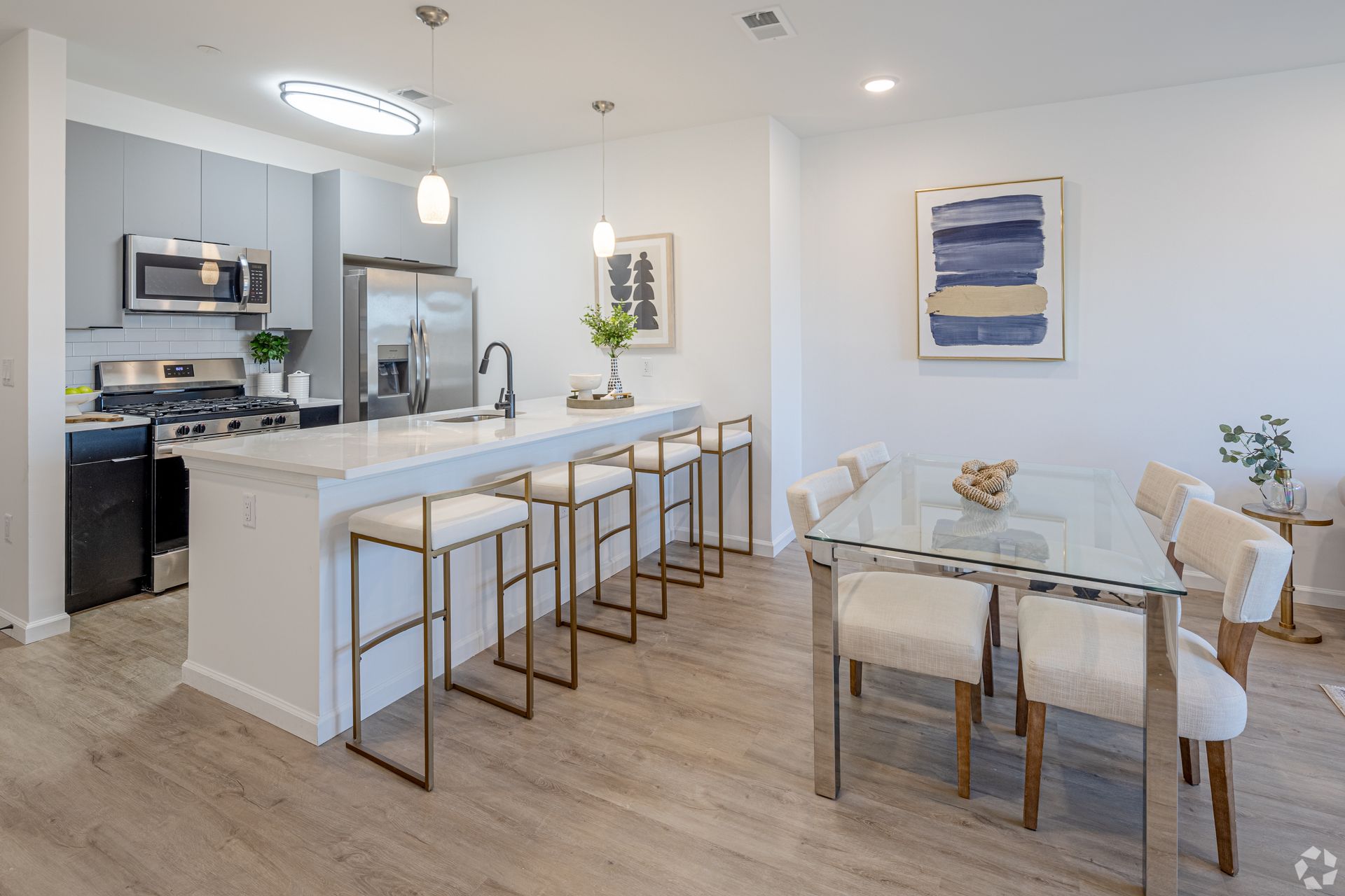 A kitchen and dining room in a house with a table and chairs.- The Unity