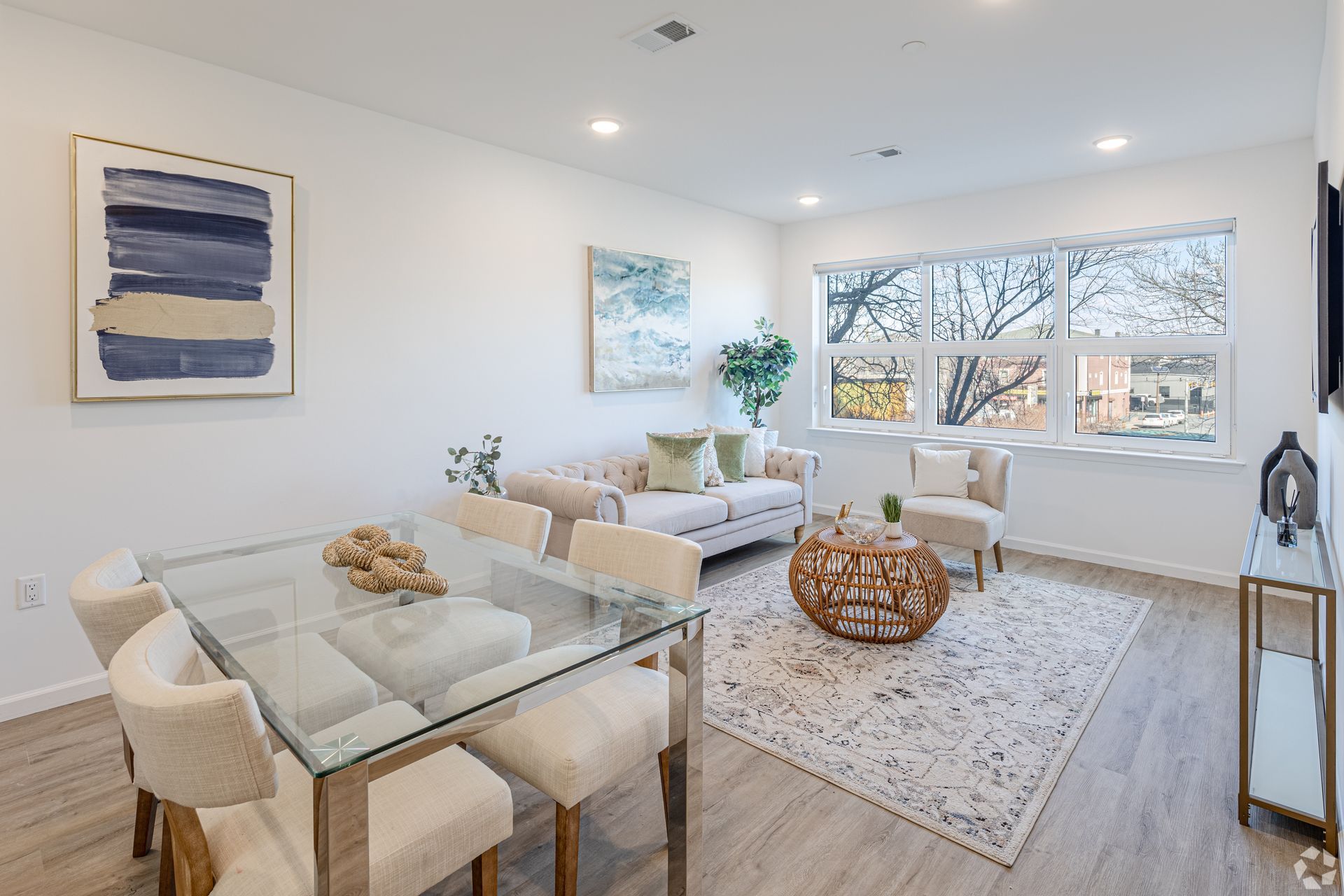A living room with a glass table and chairs and a couch.- The Unity