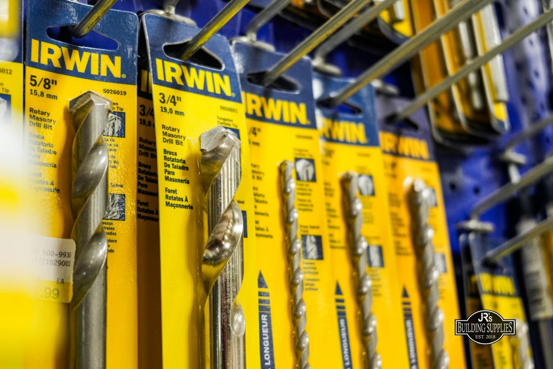 A bunch of irwin drill bits are lined up on a shelf