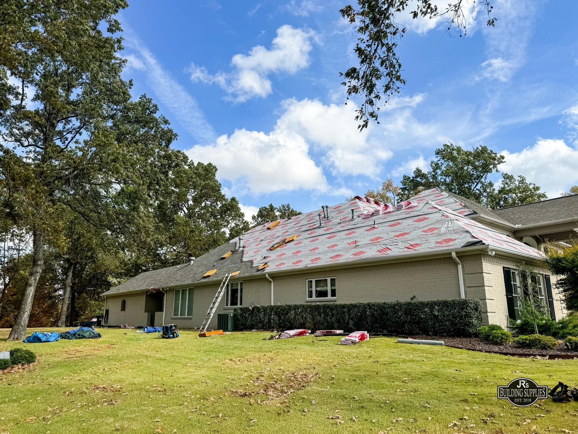 A house is being remodeled with a new roof being installed.