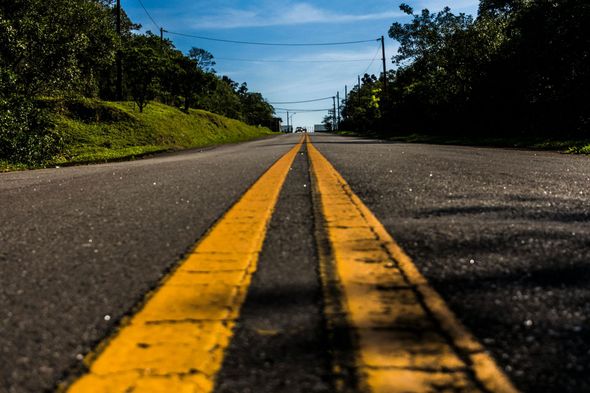 A road with a yellow line on the middle of it