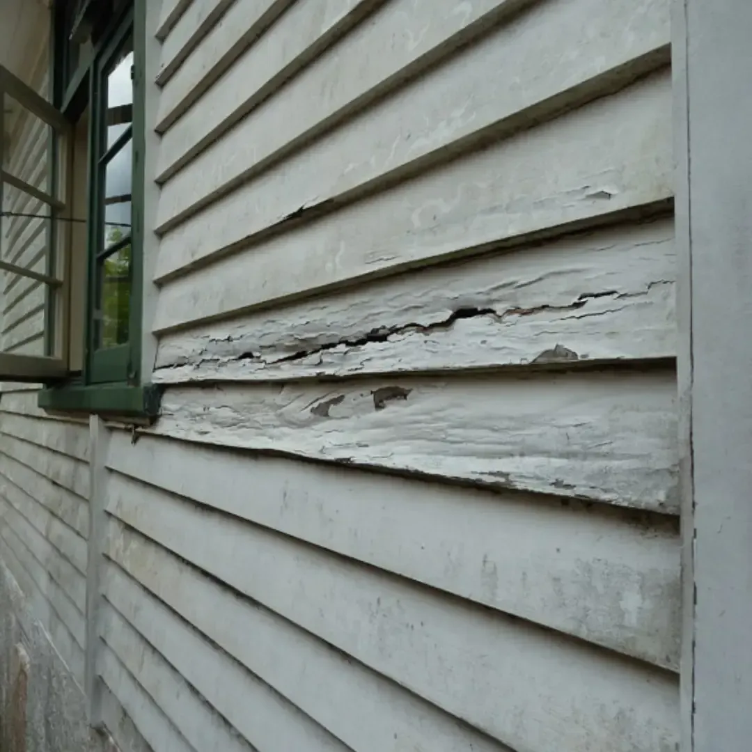 A white bathtub with beige tile walls and floor. A soap dish is mounted on the wall.