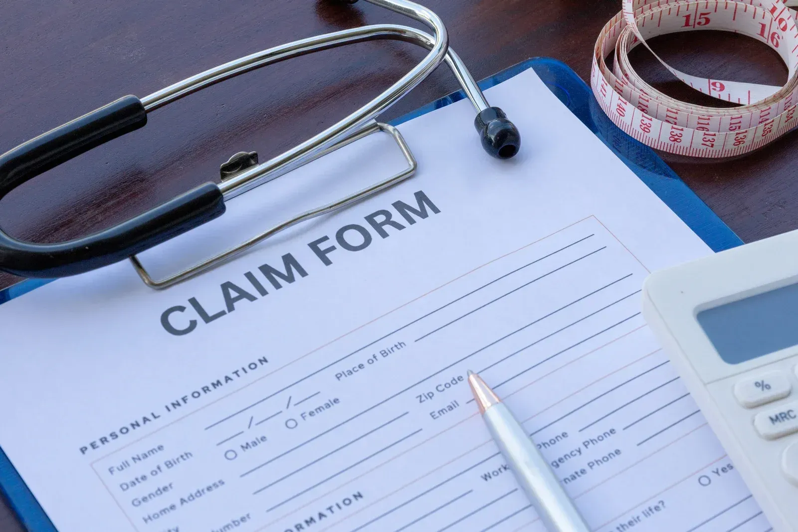 A white bathtub with beige tile walls and floor. A soap dish is mounted on the wall.