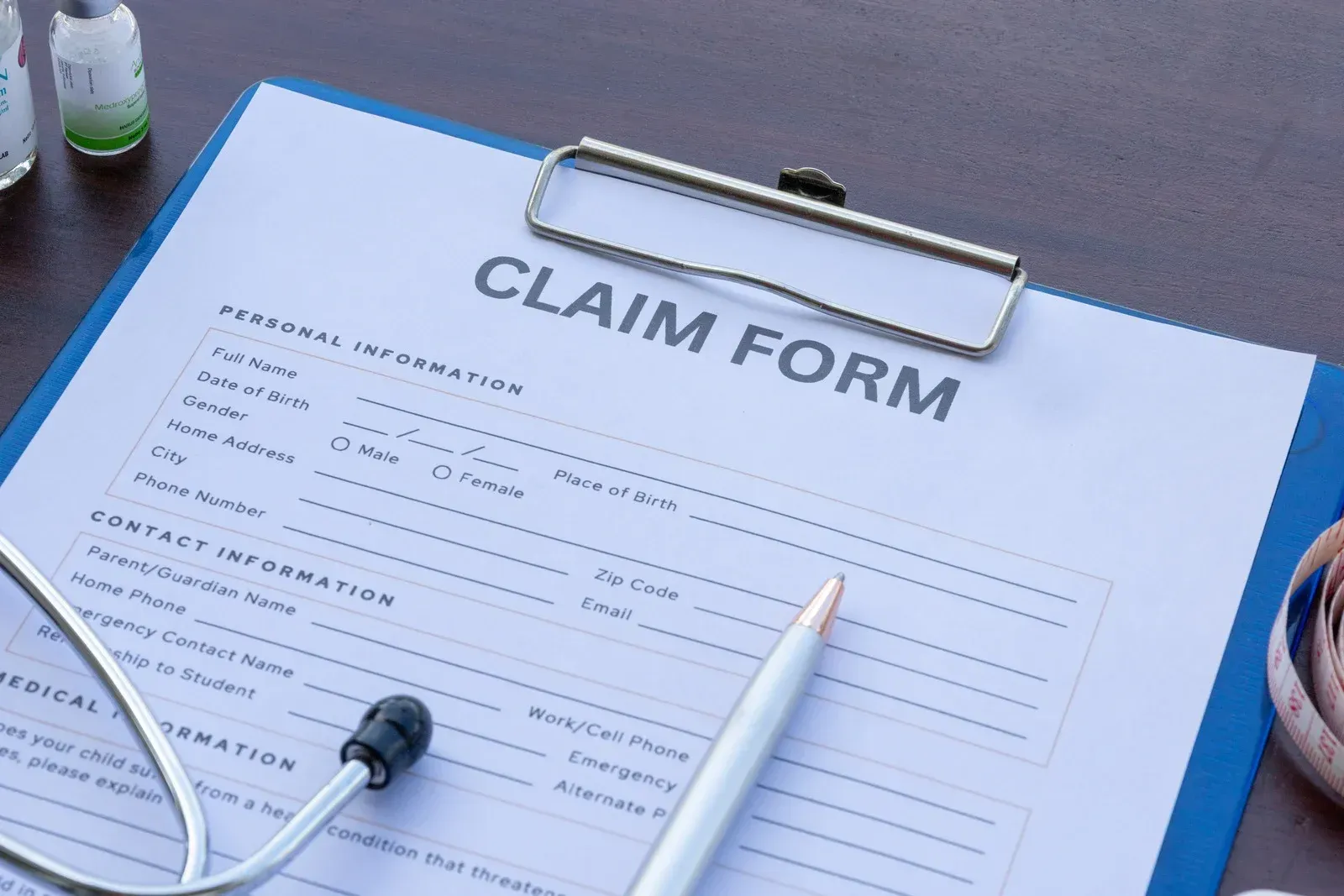 White bathtub with tiled walls in a bathroom, light brown floor, faucet on the side.