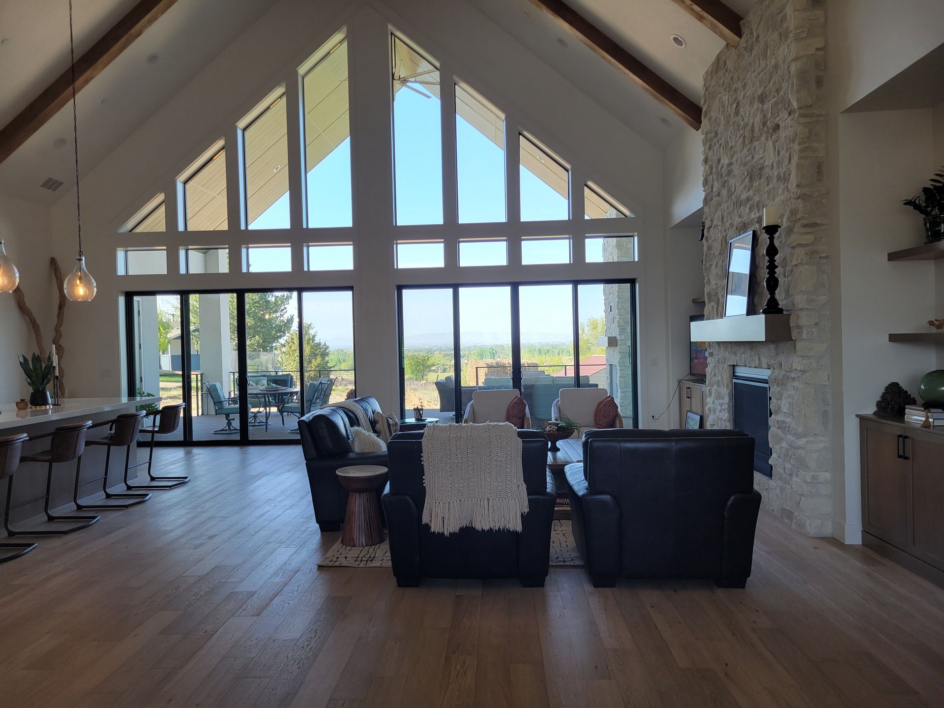 A living room with a lot of windows and a fireplace