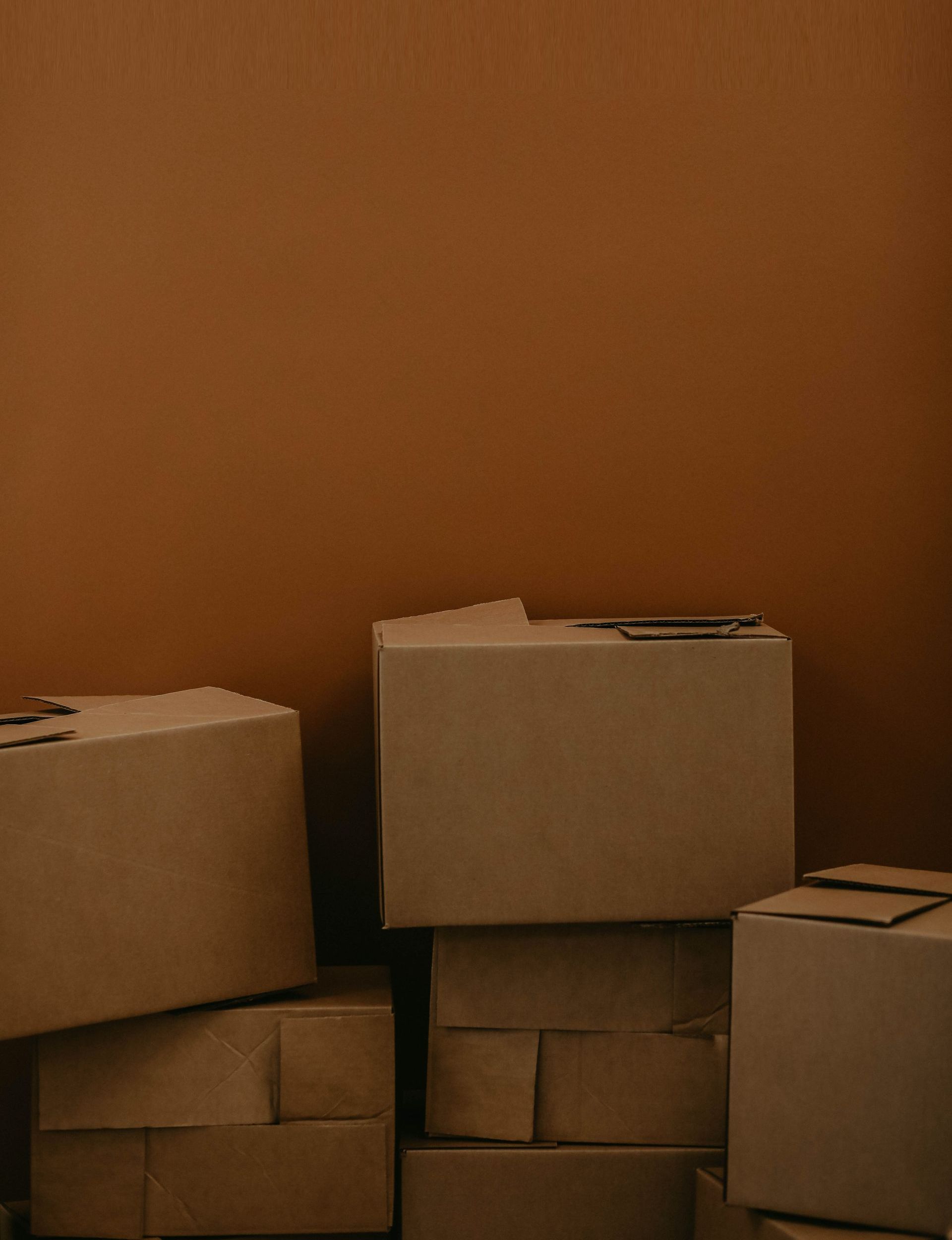 Stacked cardboard boxes neatly arranged and labeled, prepared for a move to a new location.