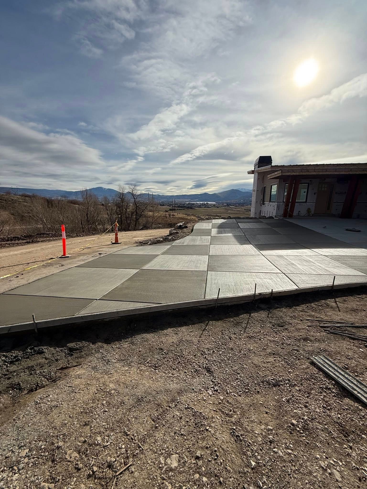 Modular, grid-like concrete pavers laid out in a desert landscape under a bright, sunny sky.