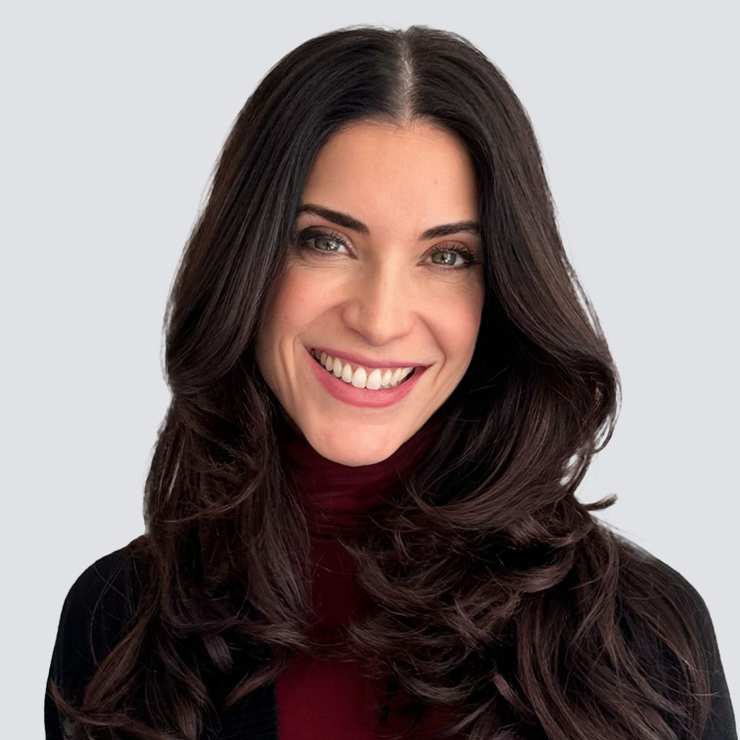 A man in a black shirt is smiling for the camera.