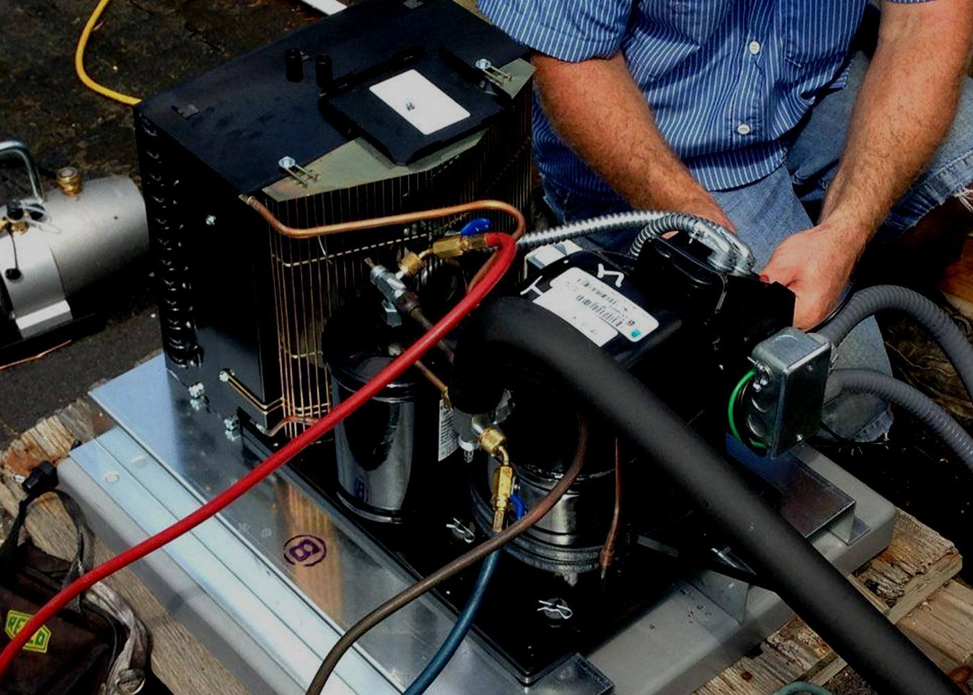a man is working on a machine with a hose attached to it