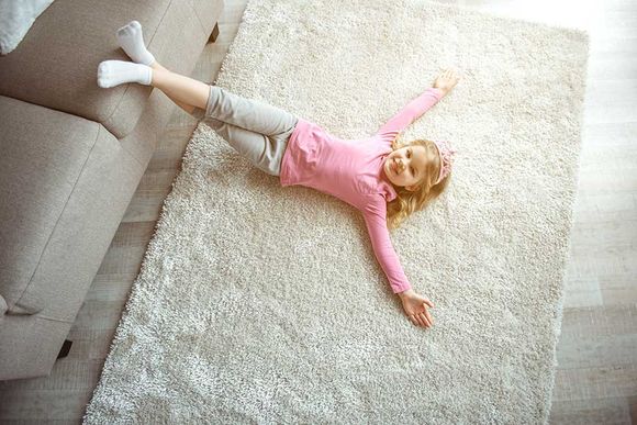 young girl lying on the carpet