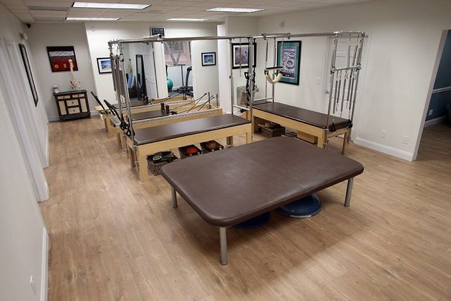 A room with a lot of tables and chairs in it